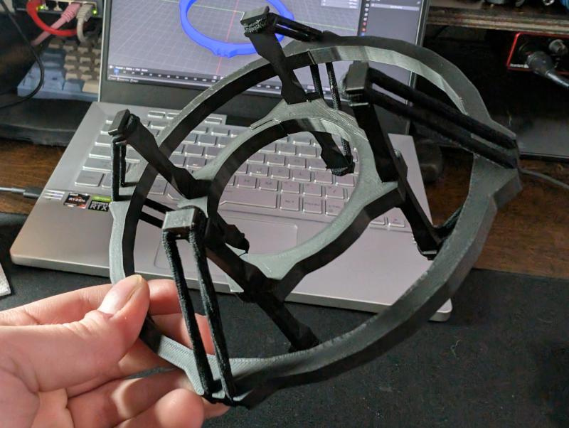 Two concentric rings connected via four legs with an elastic band